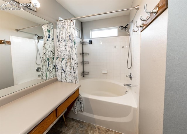 4679 Canyon Wren Ln, Colorado Springs, CO 80916 - bathroom featuring shower / bath combo with shower curtain and stone finish floors