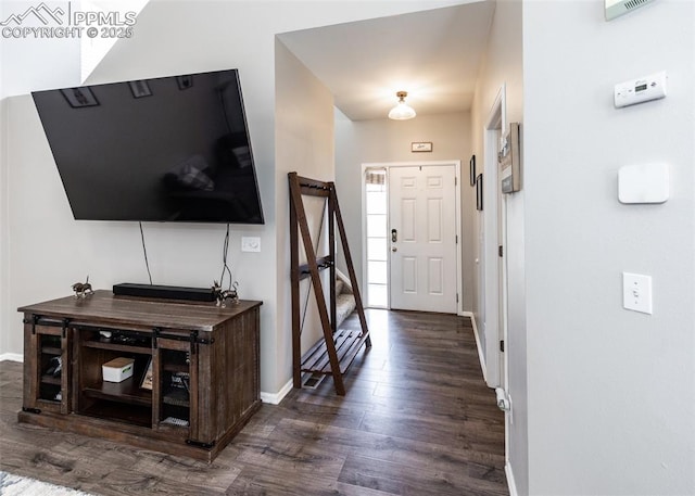 entrance foyer featuring dark wood-style floors and baseboards
