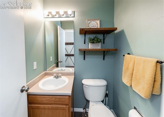 bathroom with toilet and vanity