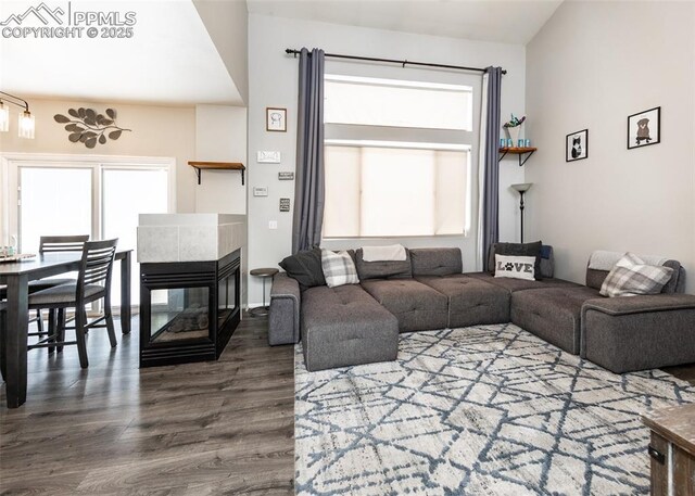 4679 Canyon Wren Ln, Colorado Springs, CO 80916 - living area featuring wood finished floors and a tiled fireplace
