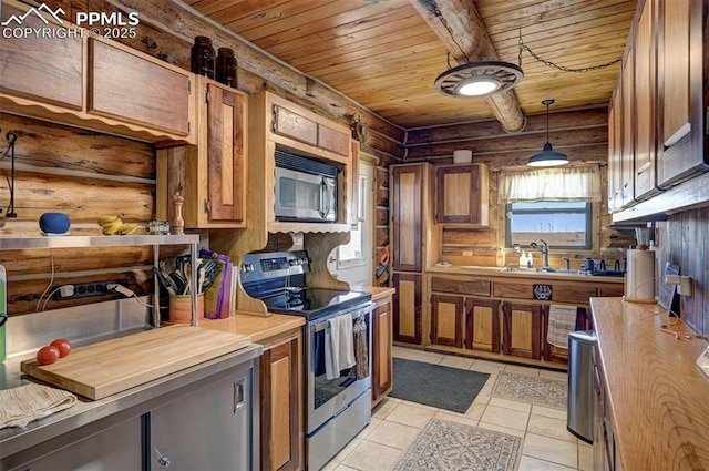 kitchen with a healthy amount of sunlight, stainless steel electric stove, brown cabinets, and a sink