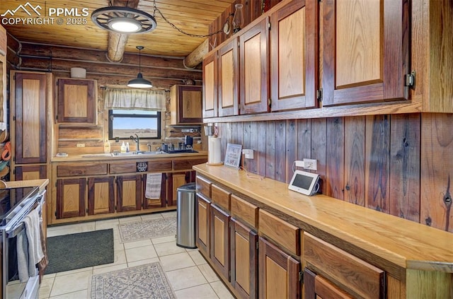 kitchen with light tile patterned floors, wood ceiling, stainless steel electric range oven, pendant lighting, and a sink