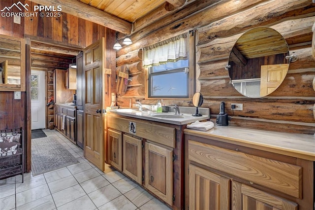 bathroom with wooden ceiling, a sink, double vanity, beamed ceiling, and rustic walls