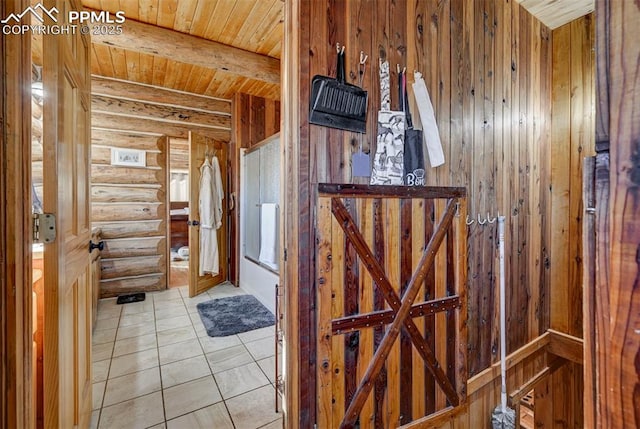 interior space featuring wooden ceiling, rustic walls, beamed ceiling, and light tile patterned floors