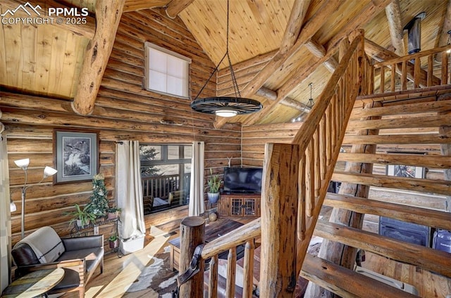 staircase with high vaulted ceiling, wood ceiling, beam ceiling, and a healthy amount of sunlight