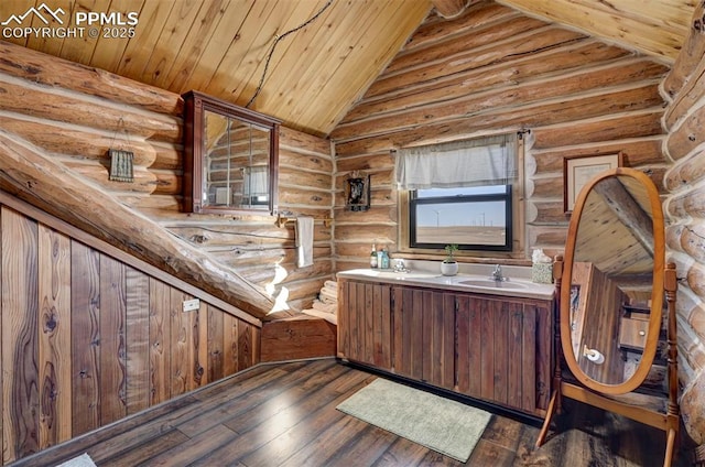 interior space featuring double vanity, wood-type flooring, wood ceiling, vaulted ceiling, and a sink