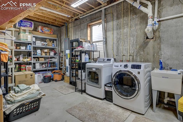 laundry room with laundry area, a sink, and independent washer and dryer