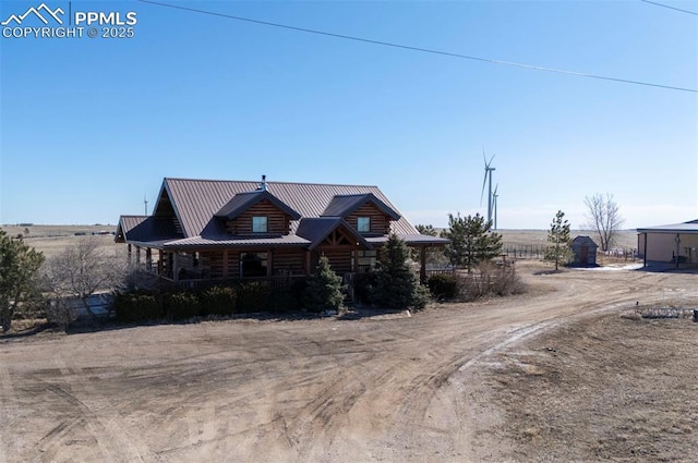 log-style house featuring metal roof and log siding