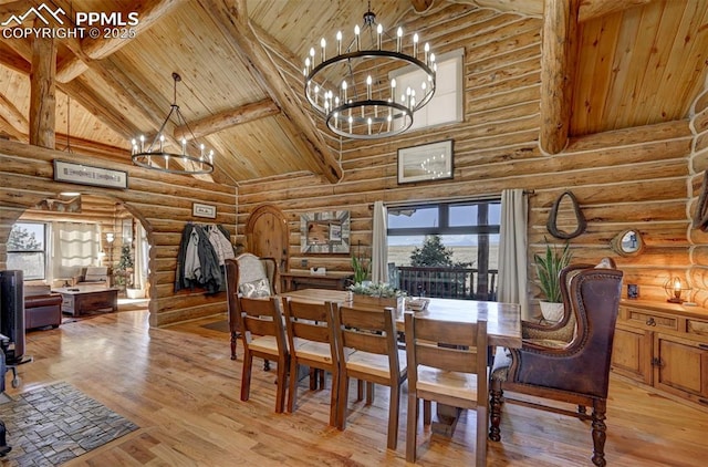 dining room with arched walkways, high vaulted ceiling, beamed ceiling, and an inviting chandelier