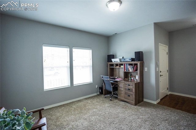 carpeted office space featuring baseboards