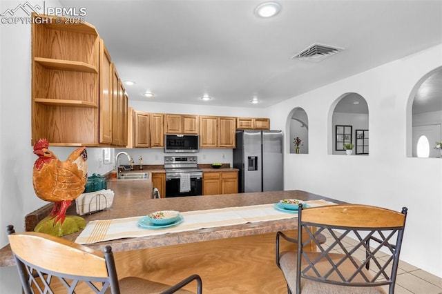 kitchen with open shelves, stainless steel appliances, recessed lighting, visible vents, and a sink