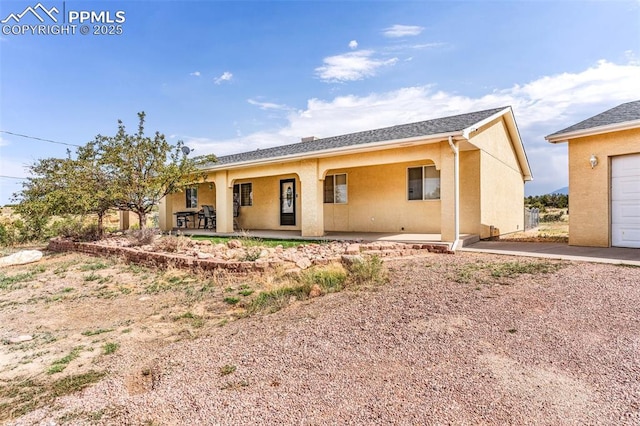 ranch-style home featuring a patio and stucco siding