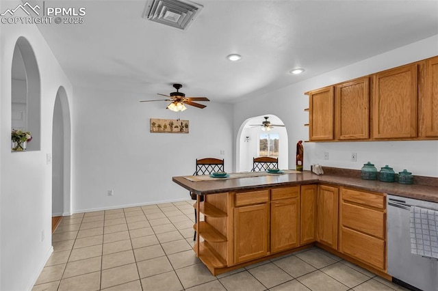 kitchen featuring dark countertops, visible vents, stainless steel dishwasher, and open shelves