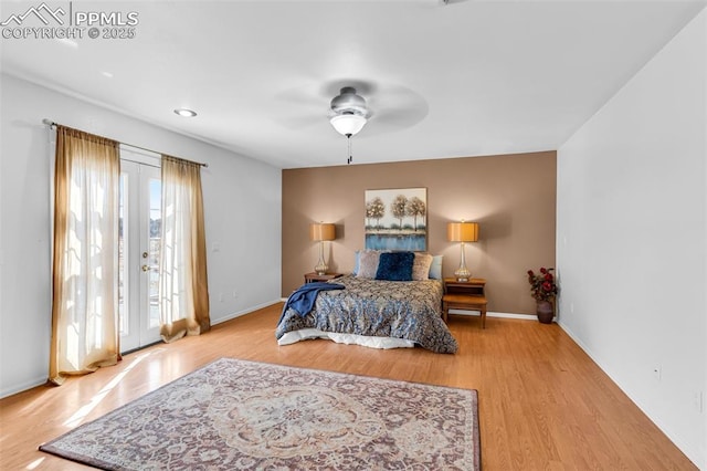 bedroom featuring a ceiling fan, access to exterior, baseboards, and wood finished floors