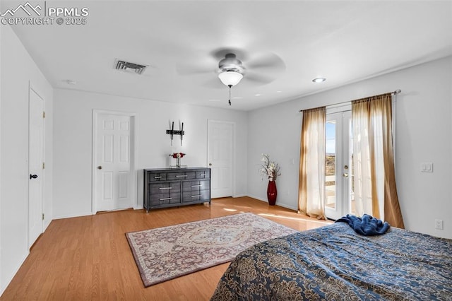 bedroom featuring wood finished floors, a ceiling fan, visible vents, access to exterior, and french doors