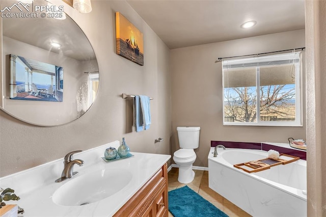 bathroom with baseboards, toilet, tile patterned floors, vanity, and a bath