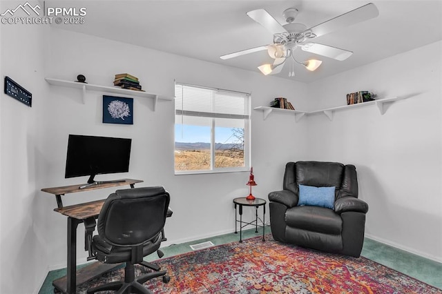 home office featuring baseboards, carpet, visible vents, and a ceiling fan