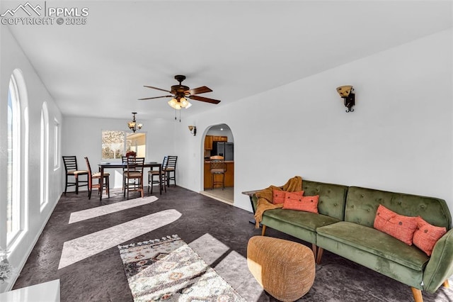 living room with arched walkways and ceiling fan