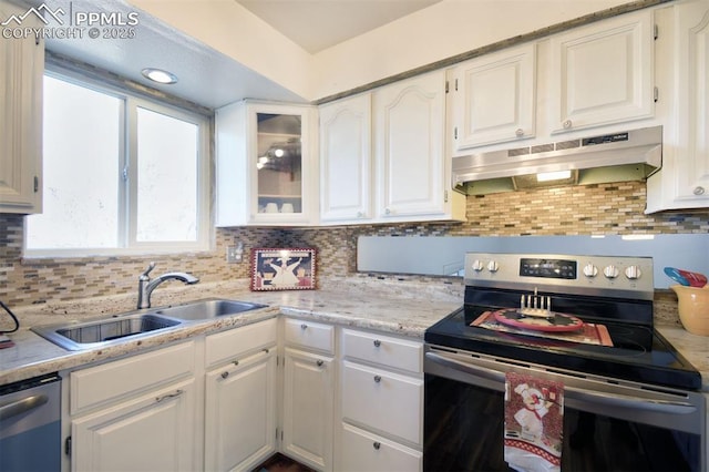 kitchen featuring white cabinets, under cabinet range hood, stainless steel appliances, and a sink