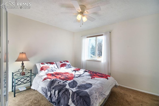 bedroom featuring a ceiling fan, carpet flooring, a textured ceiling, and baseboards