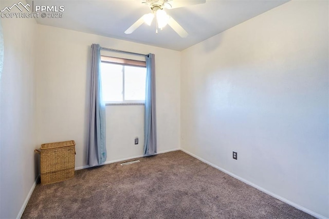 carpeted empty room featuring ceiling fan and baseboards