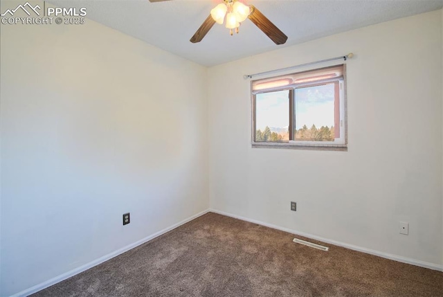 carpeted spare room featuring a ceiling fan, visible vents, and baseboards