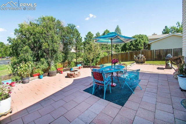 view of patio / terrace with an outdoor fire pit, outdoor dining space, and fence