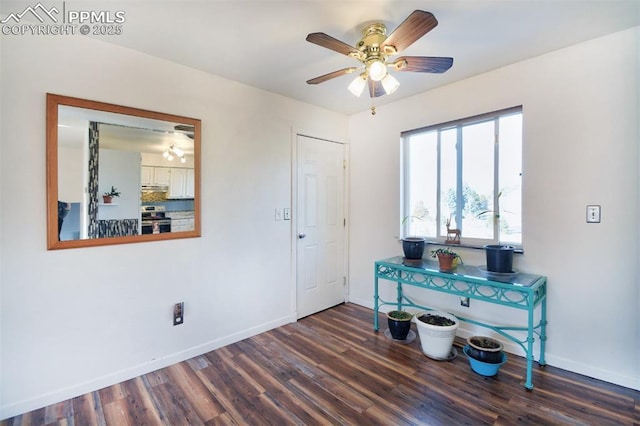 foyer entrance with ceiling fan, baseboards, and wood finished floors