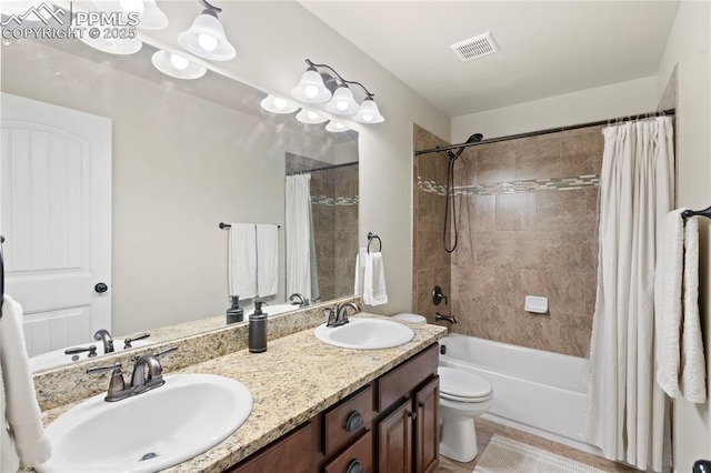 full bathroom featuring visible vents, a sink, shower / bathtub combination with curtain, and toilet