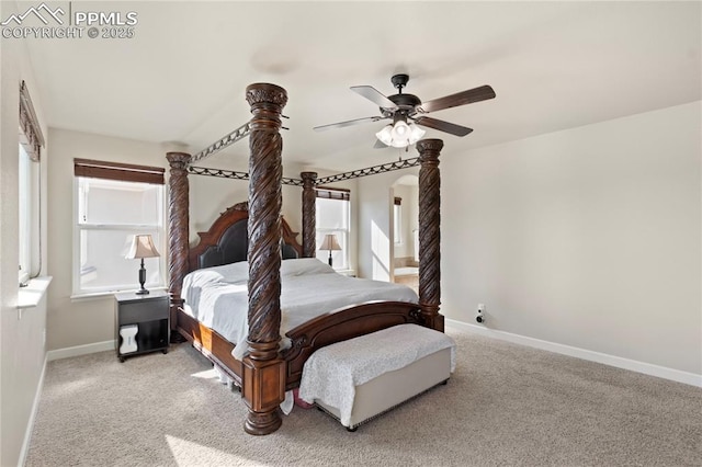 bedroom with carpet floors, ceiling fan, baseboards, and arched walkways