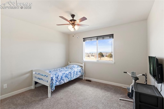 carpeted bedroom with ceiling fan and baseboards