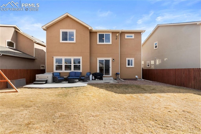 rear view of property featuring a patio, fence private yard, a yard, an outdoor living space, and stucco siding