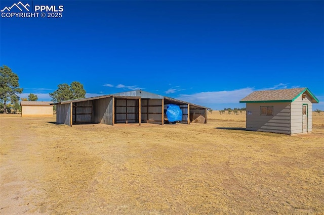 view of outbuilding featuring a carport and an outdoor structure