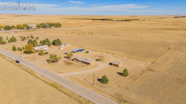 birds eye view of property with a rural view