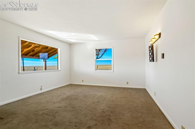 spare room with carpet flooring and baseboards