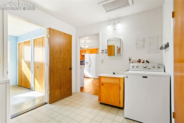 bathroom with washer / clothes dryer, a sink, and tile patterned floors