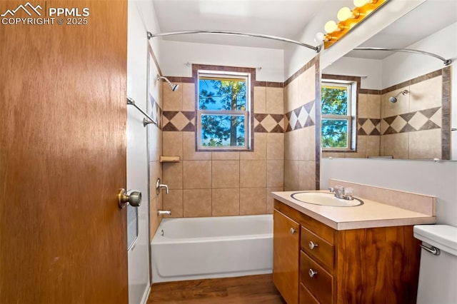 full bathroom with toilet, vanity, wood finished floors, and shower / bathtub combination