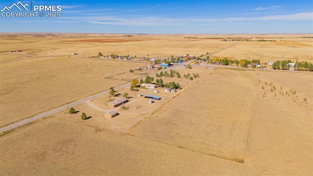 drone / aerial view featuring view of desert and a rural view