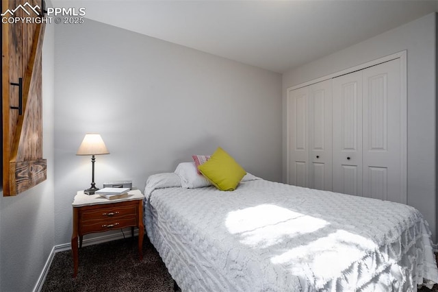 carpeted bedroom with a closet and baseboards