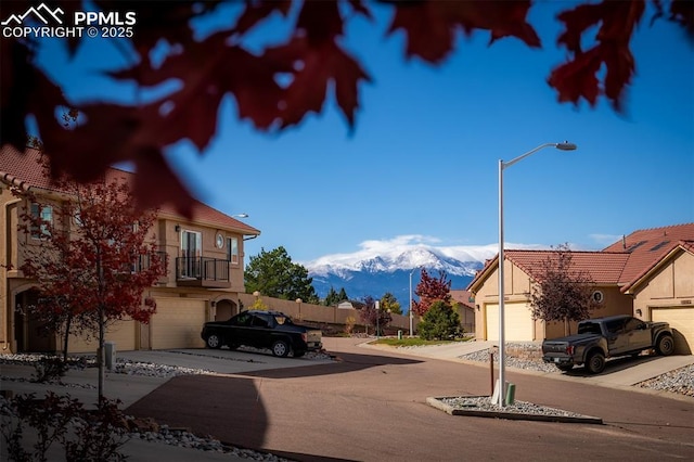 view of road featuring street lighting and a mountain view