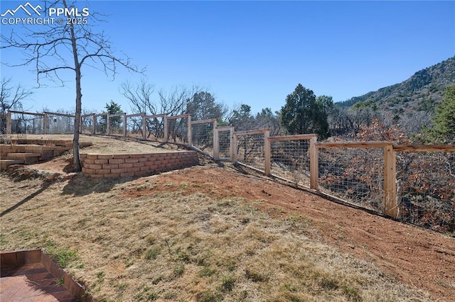 view of yard featuring fence and a gate