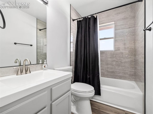 bathroom featuring toilet, shower / bath combination with curtain, wood finished floors, and vanity