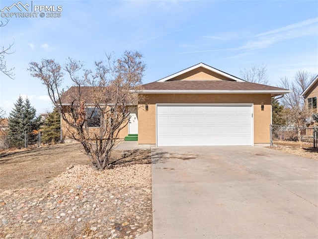 ranch-style house featuring concrete driveway, an attached garage, fence, and stucco siding