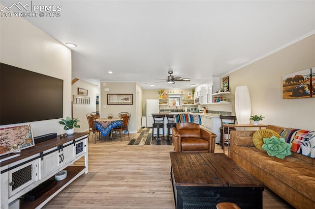 living area with baseboards, light wood-style flooring, ceiling fan, crown molding, and recessed lighting