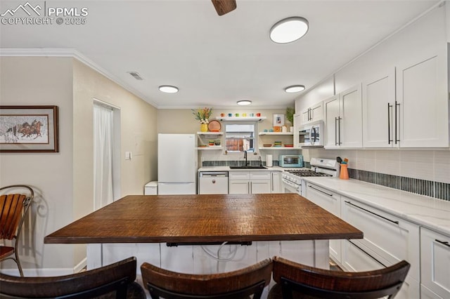 kitchen with white appliances, visible vents, crown molding, white cabinetry, and open shelves