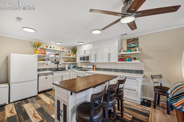 kitchen with ornamental molding, white appliances, and open shelves