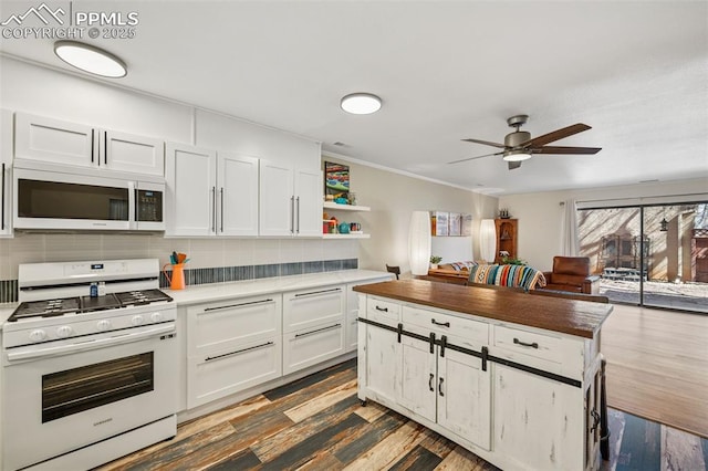 kitchen featuring white appliances, decorative backsplash, dark wood-style flooring, white cabinetry, and open shelves