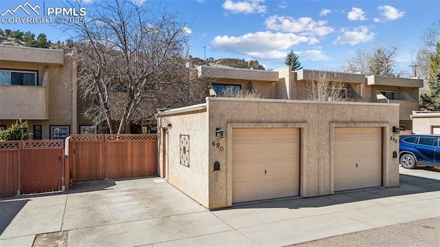 garage featuring a gate and fence