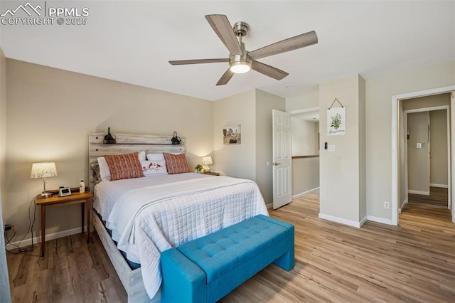 bedroom featuring ceiling fan, baseboards, and wood finished floors