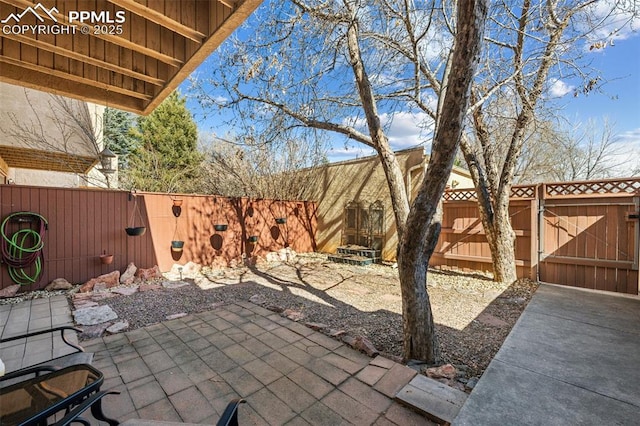 view of patio featuring a fenced backyard and a gate